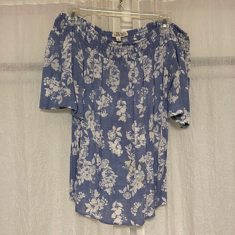 Light blue off the shoulder floral shirt.